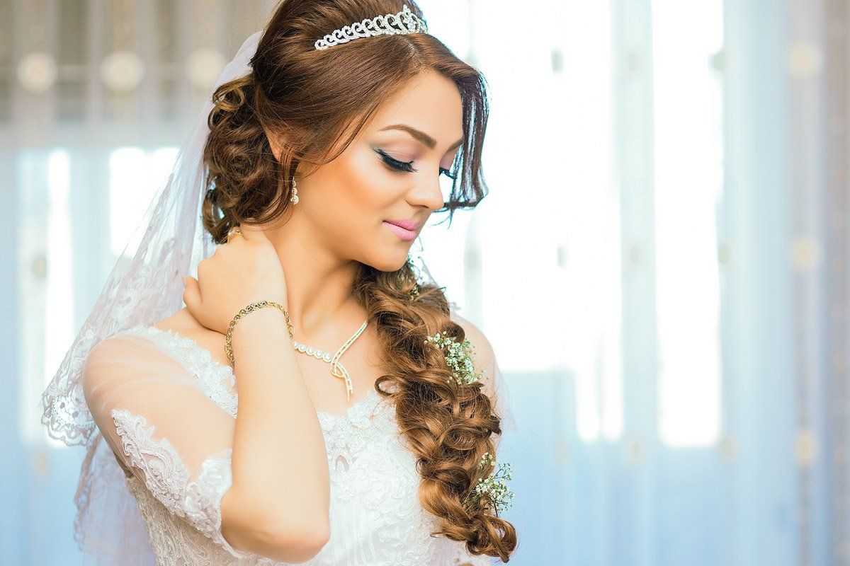 Bride with elegant updo hairstyle getting ready for her wedding at Hair Success in Fargo, ND
